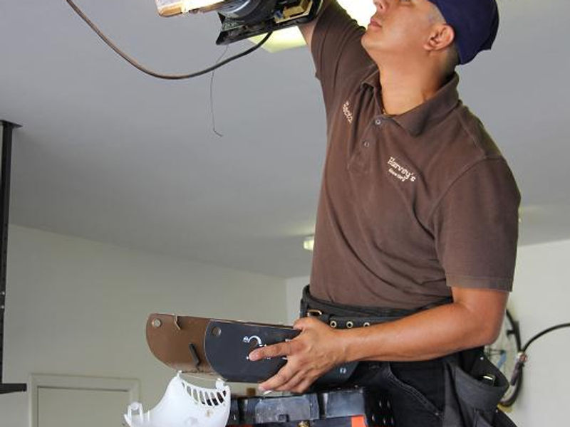 Harvey's technician performing a garage door repair in the Coachella Valley